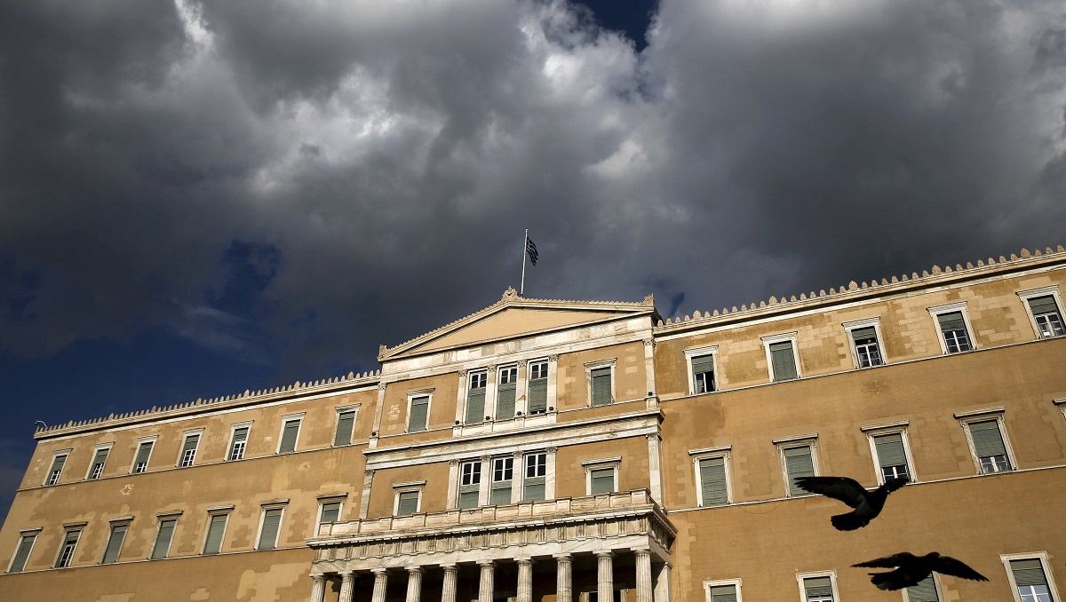 A Greek national flag flutters atop the parliament building in Athens, Greece April 11, 2016. REUTERS/Alkis Konstantinidis/File Photo