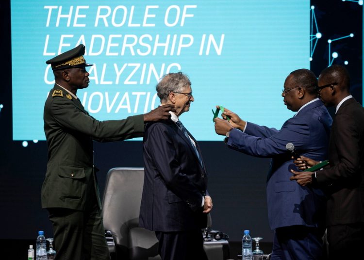 epa10909399 Macky Sall (2-R), President of Senegal, presents Bill Gates (C), founder of the Bill and Melinda Gates Foundation, with the Senegalese National Order of the Lion during the Grand Challenges Annual Meeting 2023 opening ceremony in Dakar, Senegal, 09 October 2023. Great Challenges, supported by the Bill and Melinda Gates Foundation, promotes crowdsourcing solutions for requests to grant proposals in areas such as global health science and innovation. It is the first time the annual meeting has been held in West Africa. EPA/JEROME FAVRE