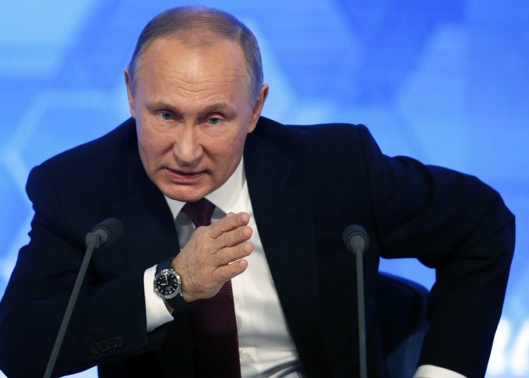 epa05686539 Russian President Vladimir Putin gestures while answering a question during his annual press conference in International Trade Center in Moscow, Russia, 23 December 2016. A total of 1,437 journalist from all regions of Russia are accredited at the press conference with many of them using various creative ways to attract the attention of the Russian leader and to ask their questions. EPA/YURI KOCHETKOV