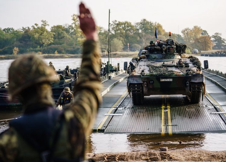 epa08767677 German Bundeswehr Army soldiers practice the crossing of the river Elbe with a Marder tank at the crossing point between Storkau (Elbe) and Hohengoehren, in Storkau (Elbe) , Germany, 23 October 2020. The soldiers performed the crossing of the river Elbe on their way to the Altmark military training area for the NATO exercise ’Heidesturm’ (Heide storm) for a NATO mission in Lithuania. The transfer to Lithuania is planned for early 2021. ’Heidesturm’ runs from 19 October to 06 November 2020. Originally planned under participation of the Dutch army, the Dutch participation was cancelled due to a coronavirus case on the Dutch side. 250 Soldiers and 100 vehicles, amongst them, Leopard 2 tanks, Marder armored personnel carriers and the armored Boxer GTK where part of the ferry service. EPA/CLEMENS BILAN