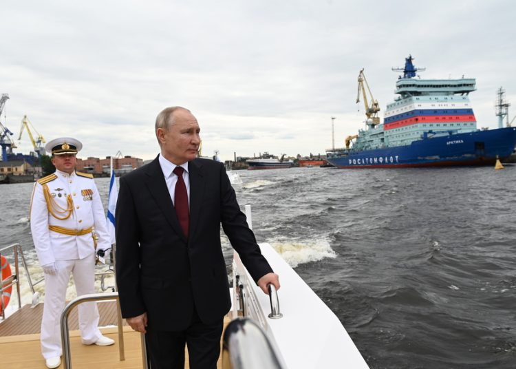 epa09365245 Russian President Vladimir Putin (L) sails on the Neva river after the 'Russia Navy Day' parade in St. Petersburg, Russia, 25 July 2021. 54 warships, including three frigates from India, Iran and Pakistan, 48 aircraft and more than 4,000 servicemen, took part in the parade in honor of the 325th anniversary of the creation of the Russian military fleet. EPA/ALEXEI NIKOLSKY/SPUTNIK/KREMLIN POOL