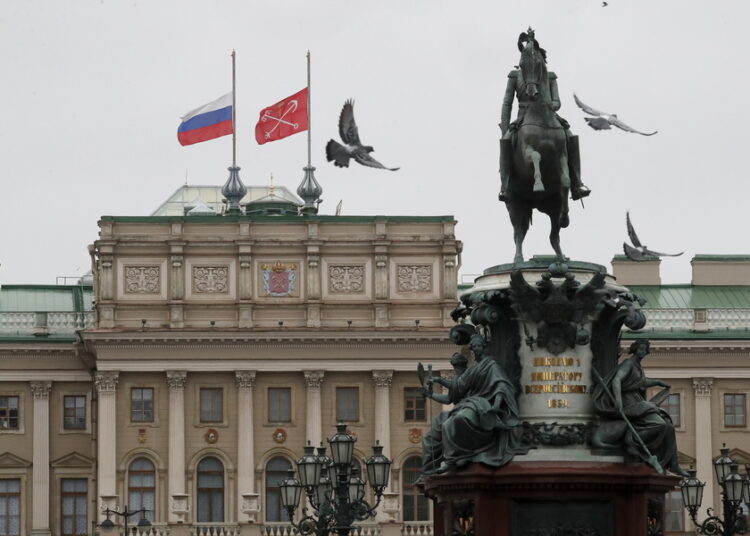 epa11238809 The Russian national flag (L) and the flag of St. Petersburg (C) fly at half-mast on the Legislative Assembly as a sign of condolences to the people of Russia following the terrorist attack at the Crocus City Hall in the Moscow region, in St. Petersburg, Russia, 23 March 2024. On 22 March evening, a group of up to five gunmen attacked the Crocus City Hall in the Moscow region, Russian emergency services said. 93 people were killed and more than 100 others were hospitalized, the Investigative Committee confirmed. The head of the Russian FSB, Alexander Bortnikov, reported to Russian President Vladimir Putin on 23 March on the arrest of 11 people, including all four terrorists directly involved in the terrorist attack. EPA/ANATOLY MALTSEV