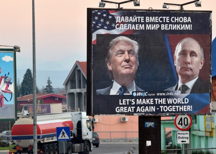 epa05634156 A billboard by pro-Serbian movement shows the image US President-elect Donald Trump and Russian President Vladimir Putin as a truck drives past in the town of Danilovgrad, Montenegro, 16 November 2016. Presidents Donald Trump and Vladimir Putin spoke by phone of better relations in the future between Washington and Moscow on 15 November. EPA/BORIS PEJOVIC