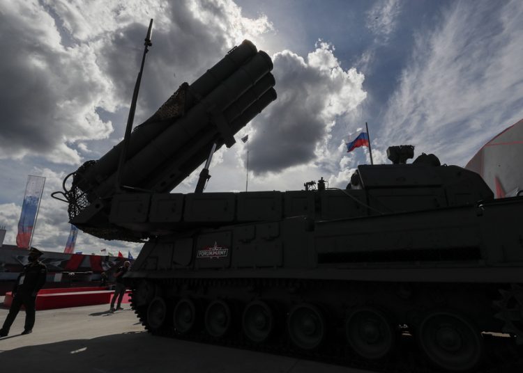 epa08619965 A specialist wearing face mask walks near a new Russian Buk-M3 Viking defense missile system at the Army 2020 International Military Technical Forum in Patriot Park in Alabino, Moscow region, Russia, 23 August 2020. The 6th International Military-Technical Forum 'Army-2020' is held from 23 till 29 of August 2020 at Patriot Expo, Kubinka Air Base and Alabino military training grounds.  EPA/SERGEI ILNITSKY
