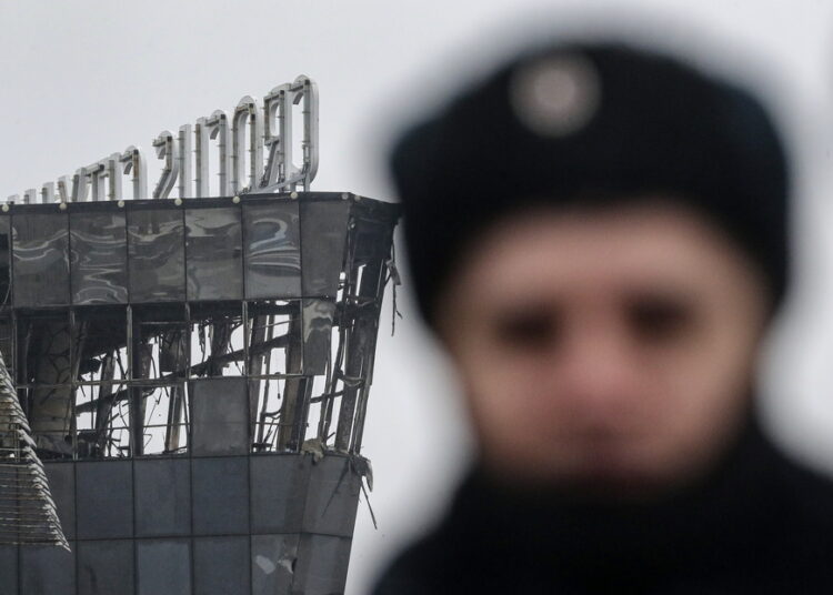 epa11238306 A Russian policeman guards near the burned Crocus City Hall concert venue following a terrorist attack in Krasnogorsk, outside Moscow, Russia, 23 March 2024. On 22 March evening, a group of up to five gunmen attacked the Crocus City Hall in the Moscow region, Russian emergency services said. 93 people were killed and more than 100 others were hospitalized, the Investigative Committee confirmed. The head of the Russian FSB, Alexander Bortnikov, reported to Russian President Vladimir Putin on 23 March on the arrest of 11 people, including all four terrorists directly involved in the terrorist attack. EPA/MAXIM SHIPENKOV