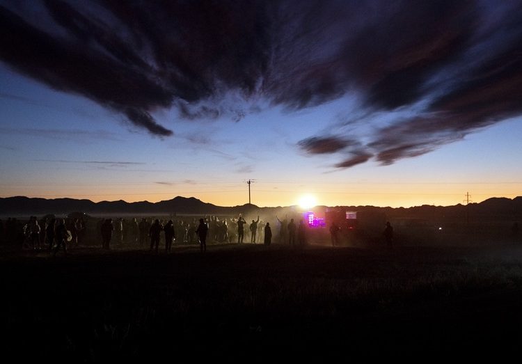 epaselect epa07857976 People dance during a DJ set at 'Alienstock' in Rachel, Nevada, USA, 20 September 2019. Starting as a joke, the 'Storm Area 51' event transformed into a gathering for alien believers, with music and attractions held in several places around Area 51.  EPA/ETIENNE LAURENT