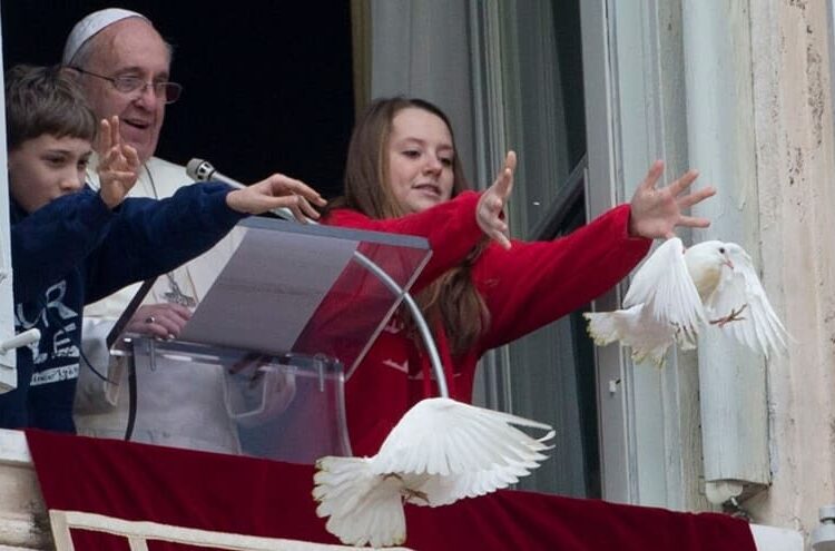 Pope Francis and two children release doves from the window of his studio overlooking St. Peter's Square.

PHOTOGRAPH BY GREGORIO BORGIA, AP